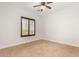 This bedroom features tiled floors, neutral walls, and a wooden shuttered window at 2110 E Kerry Ln, Phoenix, AZ 85024