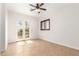 Light-filled bedroom with tile flooring, French doors, and shuttered window allowing for natural light and scenic views at 2110 E Kerry Ln, Phoenix, AZ 85024