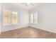 Minimalist bedroom boasts hardwood floors and shuttered windows offering light and privacy at 2110 E Kerry Ln, Phoenix, AZ 85024