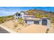 Stunning multi-story home on a hillside, featuring a three-car garage, a light-grey exterior and a unique turret design at 2110 E Kerry Ln, Phoenix, AZ 85024
