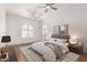 Bright main bedroom featuring hardwood floors, ceiling fans, and two arched windows at 2110 E Kerry Ln, Phoenix, AZ 85024