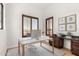 Home office space with dual workspaces, hardwood floors, and great natural light from the shuttered windows at 2110 E Kerry Ln, Phoenix, AZ 85024