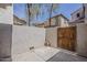 Private backyard featuring a concrete patio, wood fence, and gate access to an outdoor space at 2144 W Barwick Dr, Phoenix, AZ 85085