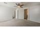 Bedroom featuring carpet flooring, a ceiling fan, and multiple doorways at 2144 W Barwick Dr, Phoenix, AZ 85085