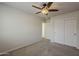 Bedroom features carpet flooring, ceiling fan, and closet with double doors at 2144 W Barwick Dr, Phoenix, AZ 85085