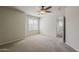 Spacious bedroom features a ceiling fan and bright window at 2144 W Barwick Dr, Phoenix, AZ 85085