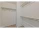 Walk-in closet featuring white walls and shelving for ample storage at 2144 W Barwick Dr, Phoenix, AZ 85085