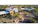 Aerial view of community pool and clubhouse with lush landscaping, water features, and a winding driveway at 2144 W Barwick Dr, Phoenix, AZ 85085