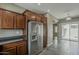 Kitchen view showing stainless steel refrigerator and dark cabinetry at 2144 W Barwick Dr, Phoenix, AZ 85085