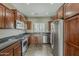 Well-equipped kitchen features stainless steel appliances, granite countertops, and rich wood cabinetry at 2144 W Barwick Dr, Phoenix, AZ 85085