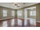 Spacious living room featuring gleaming hardwood floors, a ceiling fan, and lots of natural light at 2144 W Barwick Dr, Phoenix, AZ 85085