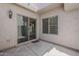 Cozy patio with a sliding glass door and a stucco wall with a light fixture at 2144 W Barwick Dr, Phoenix, AZ 85085