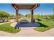 Community picnic area features shaded seating, a grill, and green space for neighborhood residents to enjoy at 2144 W Barwick Dr, Phoenix, AZ 85085