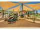 Community playground provides climbing structures, slides, and swings under a large sunshade with engineered wood fiber at 2144 W Barwick Dr, Phoenix, AZ 85085