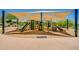 Community playground provides climbing structures, slides, and swings under a large sunshade on a sunny day at 2144 W Barwick Dr, Phoenix, AZ 85085