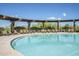 Large outdoor swimming pool surrounded by comfortable lounge chairs and desert landscaping at 2144 W Barwick Dr, Phoenix, AZ 85085