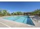 Community pool has lap lanes, lounge chairs, mountain views, and a covered structure for shaded seating on a sunny day at 2144 W Barwick Dr, Phoenix, AZ 85085