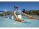 Community splash pad provides plenty of fun with a water slide, splash toys and a shallow pool on a sunny day at 2144 W Barwick Dr, Phoenix, AZ 85085