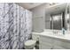 Bathroom featuring white vanity, shower/tub, and patterned shower curtain at 2146 W Isabella Ave # 127, Mesa, AZ 85202