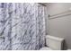 Neutral bathroom featuring toilet and marble-patterned shower curtain at 2146 W Isabella Ave # 127, Mesa, AZ 85202