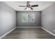 Neutral bedroom featuring modern ceiling fan, wood-look floors, and window at 2146 W Isabella Ave # 127, Mesa, AZ 85202