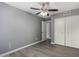 Bedroom featuring ceiling fan, wood-look floors, and closet at 2146 W Isabella Ave # 127, Mesa, AZ 85202