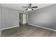 Grey bedroom with ceiling fan, closet, and modern wood-look floors at 2146 W Isabella Ave # 127, Mesa, AZ 85202