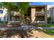 Condo building exterior with stair access, green landscaping, and an inviting entrance at 2146 W Isabella Ave # 127, Mesa, AZ 85202
