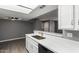 Open kitchen with white countertops, a stainless steel sink, and views to living area at 2146 W Isabella Ave # 127, Mesa, AZ 85202