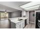 Bright kitchen featuring white cabinets, breakfast bar, updated countertops, and stainless steel sink at 2146 W Isabella Ave # 127, Mesa, AZ 85202