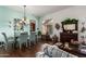 Elegant dining room with modern chandelier, large window, and designer furnishings at 22026 N 44Th Pl, Phoenix, AZ 85050