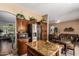 Well-lit kitchen with custom cabinets, stainless steel refrigerator, and granite island at 22026 N 44Th Pl, Phoenix, AZ 85050