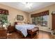 Bright main bedroom with hardwood floors, large windows, and a view of the outdoors at 22026 N 44Th Pl, Phoenix, AZ 85050