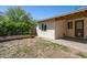 Grassy backyard features mature bushes and access to the home at 2306 W Laurel Ln, Phoenix, AZ 85029