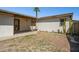 This backyard shows a grassy area, back patio, and cacti at 2306 W Laurel Ln, Phoenix, AZ 85029