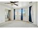Bedroom featuring plush carpeting, a ceiling fan, windows with curtains and closet with sliding mirrored doors at 2306 W Laurel Ln, Phoenix, AZ 85029