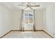 Bright bedroom with neutral paint, ceramic tile flooring, ceiling fan and window with curtains at 2306 W Laurel Ln, Phoenix, AZ 85029