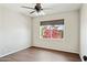 Cozy bedroom with wood-look flooring and a bright window view at 2306 W Laurel Ln, Phoenix, AZ 85029