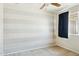 Bedroom featuring a ceiling fan, carpet, and large window at 2306 W Laurel Ln, Phoenix, AZ 85029