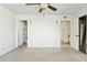 Spacious bedroom featuring plush carpet, ceiling fan, and ample closet space at 2306 W Laurel Ln, Phoenix, AZ 85029