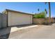 A two-car garage sits next to a lush palm tree at 2306 W Laurel Ln, Phoenix, AZ 85029
