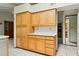 Kitchen featuring ample wooden cabinet space, white countertops, and neutral tile flooring at 2306 W Laurel Ln, Phoenix, AZ 85029