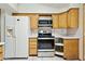 Efficient kitchen design with stainless steel appliances, wooden cabinets, and white countertops at 2306 W Laurel Ln, Phoenix, AZ 85029
