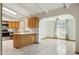 Spacious kitchen with island, wooden cabinets, and a view into the sunny breakfast nook area at 2306 W Laurel Ln, Phoenix, AZ 85029