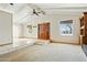 Bright living room featuring vaulted ceilings, tile entry, and neutral carpet flooring for a welcoming space at 2306 W Laurel Ln, Phoenix, AZ 85029