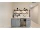Stylish bar area featuring gray cabinetry, shelving, wine cooler, and countertop space at 2335 E Allen St, Phoenix, AZ 85042