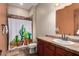 Charming bathroom features a warm color scheme, shower with decorative curtain, and stylish vanity at 2335 E Allen St, Phoenix, AZ 85042