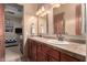 Double vanity in the bathroom offers plenty of space, with wooden cabinets and tiled countertops at 2335 E Allen St, Phoenix, AZ 85042