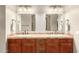 Elegant bathroom with double sink vanity, warm lighting, and well-crafted wood cabinets offer a relaxing experience at 2335 E Allen St, Phoenix, AZ 85042