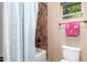 Bright bathroom with tiled shower and geometric shower curtain, and a pink towel at 2335 E Allen St, Phoenix, AZ 85042